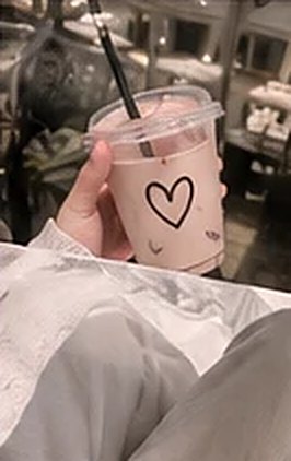 An iced drink with a heart drawn on the cup