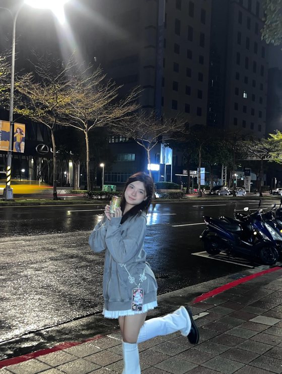 Beaker posing on a city street at night